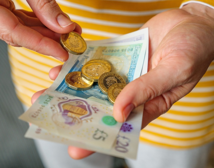 A woman holding cash in her hands.