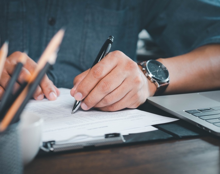 A man making notes on paperwork.